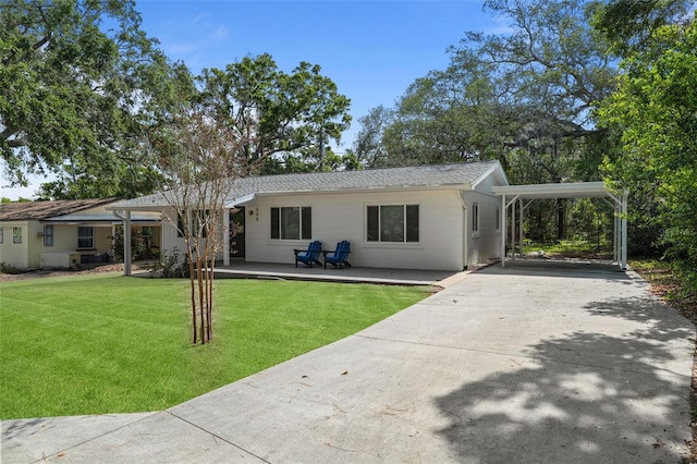 608 Betmor Ln, Palm Harbor, FL 34683 - rear view of property featuring driveway and a lawn