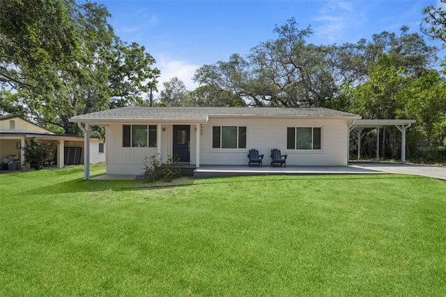 608 Betmor Ln, Palm Harbor, FL 34683 - rear view of property featuring a lawn, an attached carport, and concrete driveway