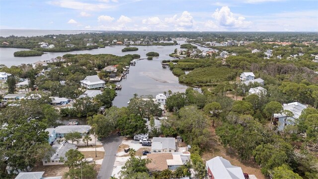 608 Betmor Ln, Palm Harbor, FL 34683 - aerial overview of property's location with a large body of water, nearby suburban area, and a tree filled landscape