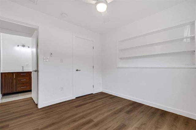3151 6th Ave S, Saint Petersburg, FL 33712 - unfurnished bedroom featuring baseboards, wood finished floors, and a ceiling fan