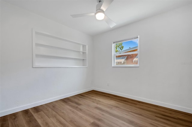 3151 6th Ave S, Saint Petersburg, FL 33712 - unfurnished room with a ceiling fan, wood finished floors, baseboards, and built in shelves