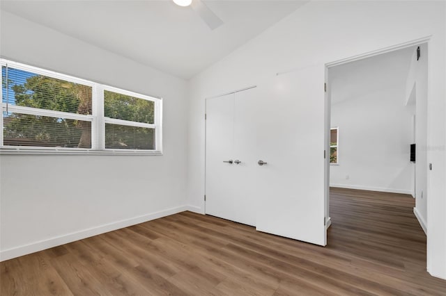 3151 6th Ave S, Saint Petersburg, FL 33712 - unfurnished bedroom featuring wood finished floors, lofted ceiling, baseboards, a closet, and ceiling fan