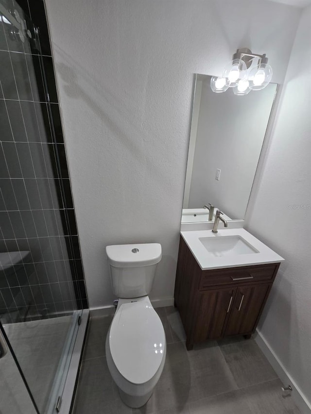 3151 6th Ave S, Saint Petersburg, FL 33712 - bathroom featuring a shower stall, tile patterned flooring, vanity, toilet, and baseboards