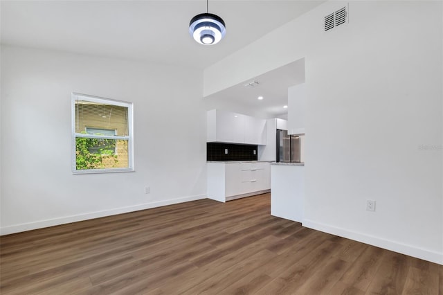 3151 6th Ave S, Saint Petersburg, FL 33712 - unfurnished living room with baseboards and wood finished floors