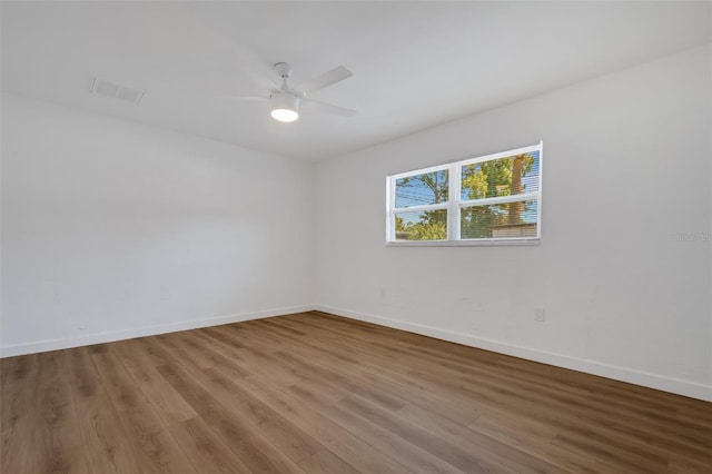 3151 6th Ave S, Saint Petersburg, FL 33712 - unfurnished room featuring baseboards, wood finished floors, and a ceiling fan
