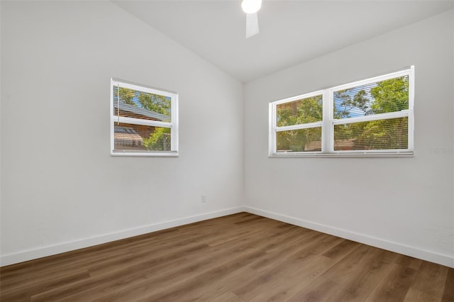 3151 6th Ave S, Saint Petersburg, FL 33712 - empty room featuring wood finished floors, baseboards, and vaulted ceiling