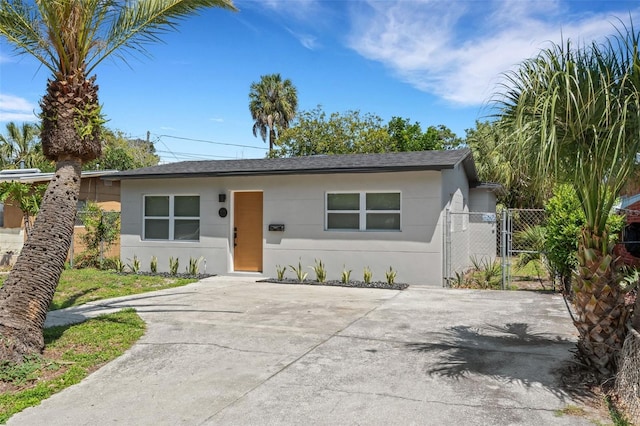 3151 6th Ave S, Saint Petersburg, FL 33712 - ranch-style home featuring stucco siding, a gate, concrete driveway, and a shingled roof