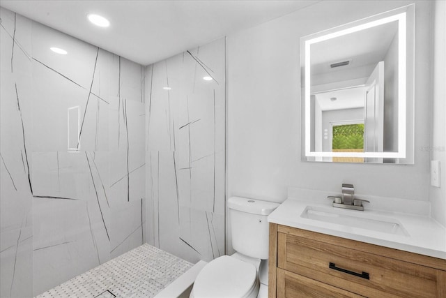 full bath featuring toilet, vanity, a marble finish shower, and recessed lighting