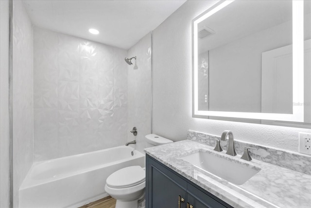 full bathroom with toilet,  shower combination, vanity, and a textured wall
