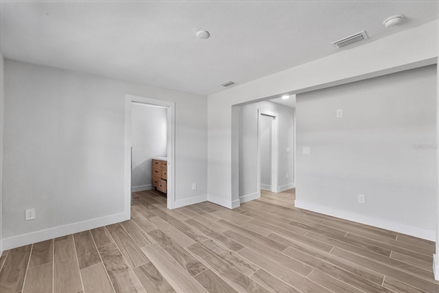 empty room featuring light wood-style flooring and baseboards