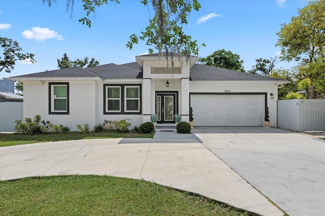 19212 Sunlake Blvd, Lutz, FL 33558 - view of front of house with a garage, stucco siding, fence, concrete driveway, and a shingled roof