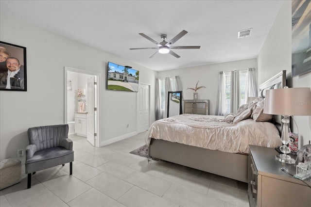 19212 Sunlake Blvd, Lutz, FL 33558 - bedroom with light tile patterned floors, a ceiling fan, connected bathroom, and baseboards