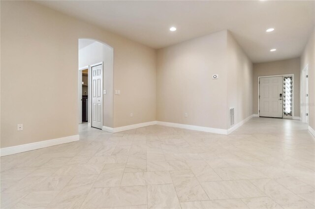 2262 Lune Ct, Melbourne, FL 32904 - unfurnished room with arched walkways, recessed lighting, and baseboards