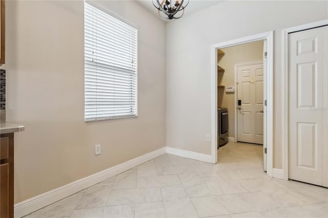 2262 Lune Ct, Melbourne, FL 32904 - unfurnished room with a chandelier, baseboards, and light marble finish floors