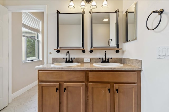 2262 Lune Ct, Melbourne, FL 32904 - bathroom featuring double vanity, marble finish flooring, and baseboards