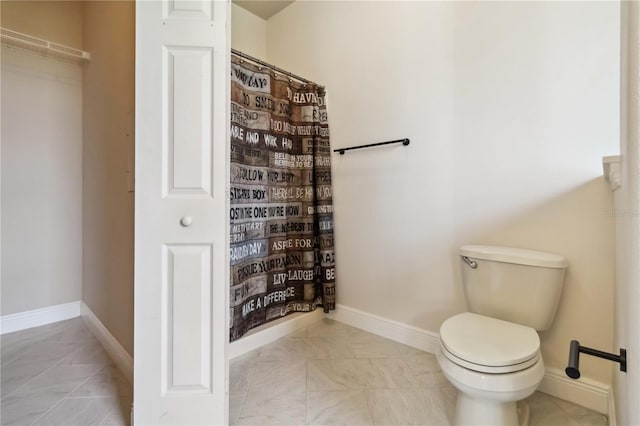 2262 Lune Ct, Melbourne, FL 32904 - bathroom with toilet, marble look tiles, baseboards, and curtained shower
