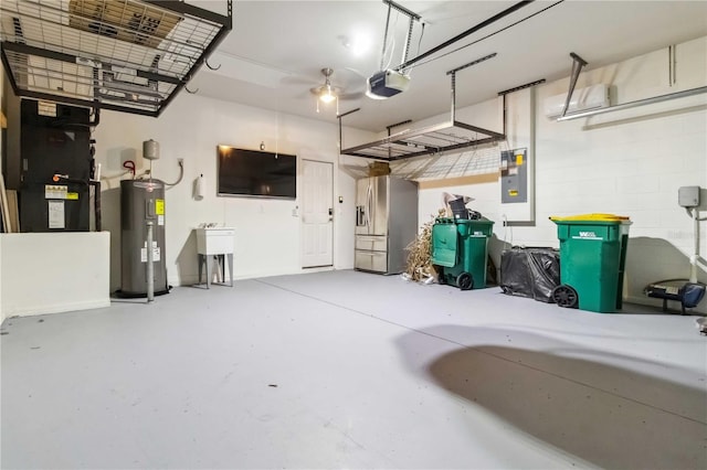 2262 Lune Ct, Melbourne, FL 32904 - garage with water heater, stainless steel fridge, electric panel, a garage door opener, and heating unit
