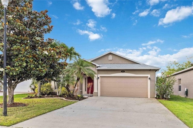 2262 Lune Ct, Melbourne, FL 32904 - view of front of home featuring stucco siding, concrete driveway, an attached garage, and a front lawn