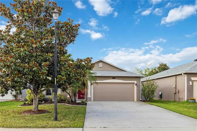 2262 Lune Ct, Melbourne, FL 32904 - view of front of home with stucco siding, an attached garage, driveway, and a front lawn