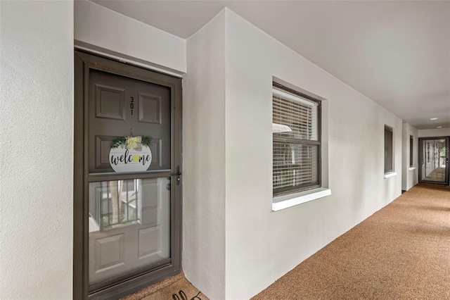 entrance to property featuring stucco siding