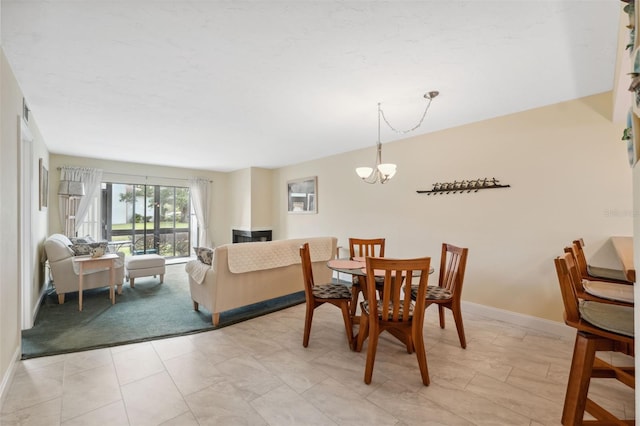 143 Lakeside Dr Unit 143, Oldsmar, FL 34677 - dining room featuring a chandelier, baseboards, and light colored carpet