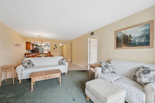 143 Lakeside Dr Unit 143, Oldsmar, FL 34677 - living area featuring carpet floors, a chandelier, and baseboards