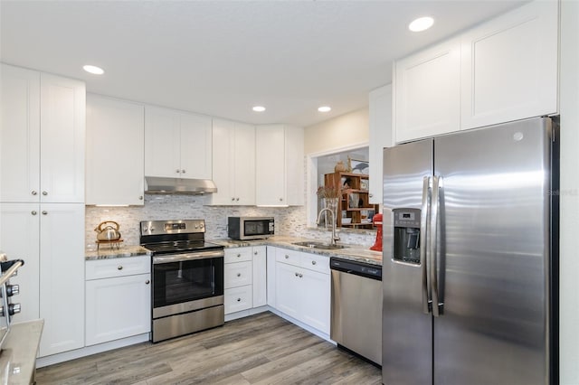 322 Windrush Loop Unit 22, Tarpon Springs, FL 34689 - kitchen with appliances with stainless steel finishes, a sink, under cabinet range hood, white cabinets, and recessed lighting