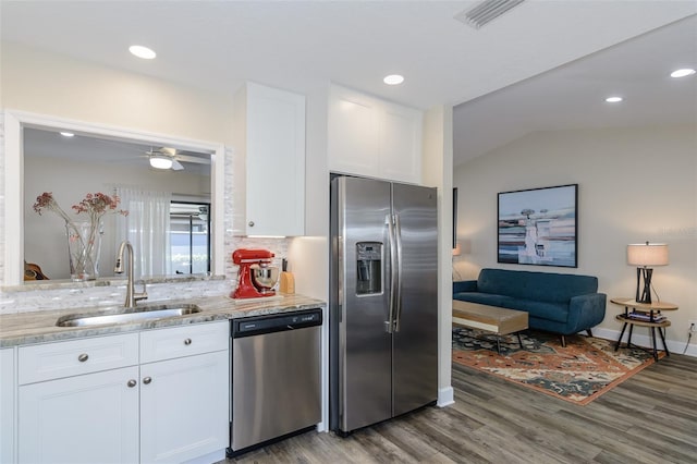322 Windrush Loop Unit 22, Tarpon Springs, FL 34689 - kitchen with appliances with stainless steel finishes, a sink, wood finished floors, white cabinets, and light stone countertops
