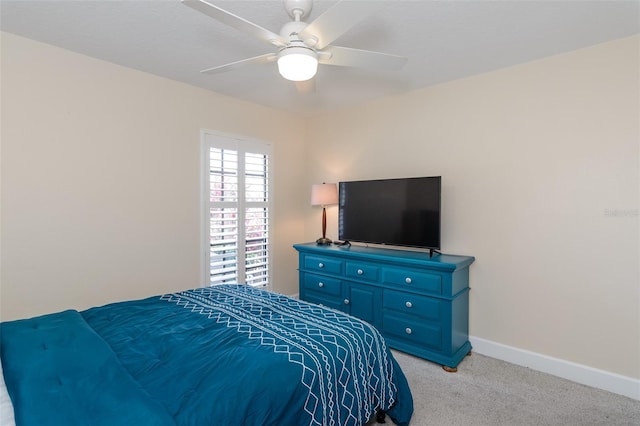 322 Windrush Loop Unit 22, Tarpon Springs, FL 34689 - bedroom featuring light carpet, baseboards, and a ceiling fan