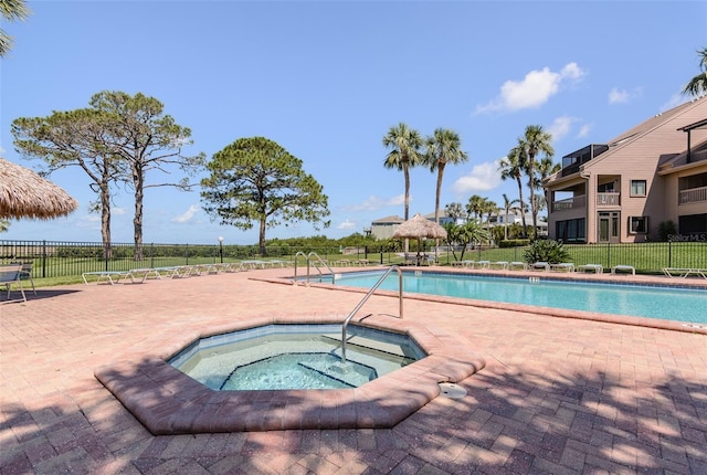 322 Windrush Loop Unit 22, Tarpon Springs, FL 34689 - community pool with a community hot tub and a patio area