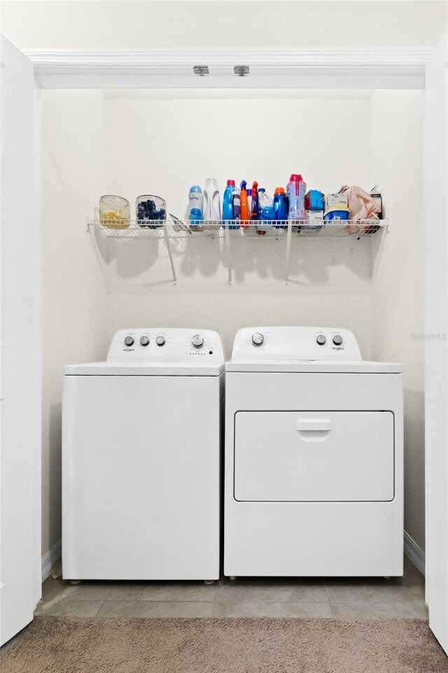 2906 Boxwood Grove Row, Wesley Chapel, FL 33543 - laundry area featuring washing machine and clothes dryer, light tile patterned flooring, and baseboards