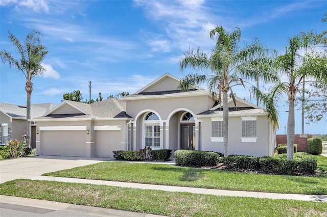 13708 Old Dock Rd, Orlando, FL 32828 - view of front of house with a garage, concrete driveway, stucco siding, a front yard, and a shingled roof