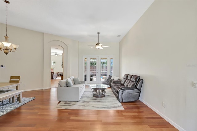 13708 Old Dock Rd, Orlando, FL 32828 - living room with ceiling fan, french doors, wood finished floors, arched walkways, and a chandelier
