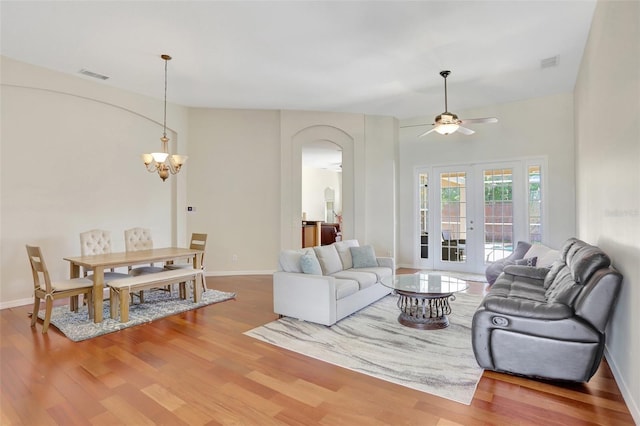 13708 Old Dock Rd, Orlando, FL 32828 - living area with arched walkways, wood finished floors, ceiling fan, and a chandelier