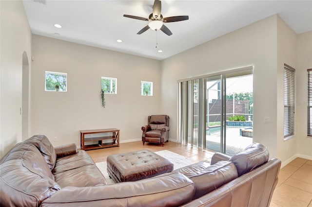 13708 Old Dock Rd, Orlando, FL 32828 - living area with ceiling fan, light tile patterned flooring, arched walkways, recessed lighting, and baseboards