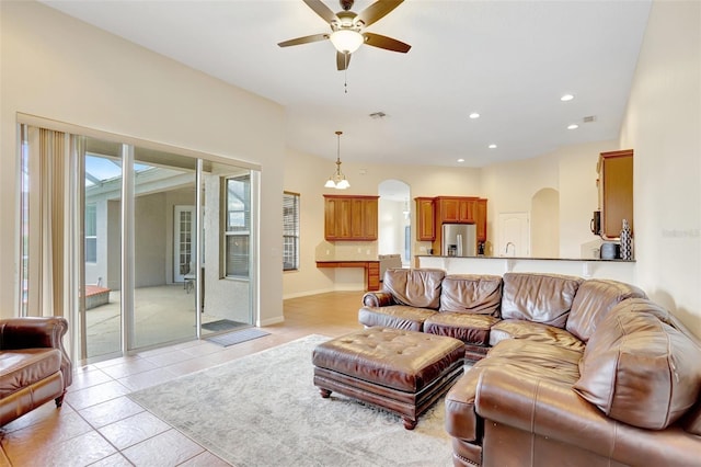 13708 Old Dock Rd, Orlando, FL 32828 - living area with arched walkways, ceiling fan, recessed lighting, light tile patterned floors, and baseboards