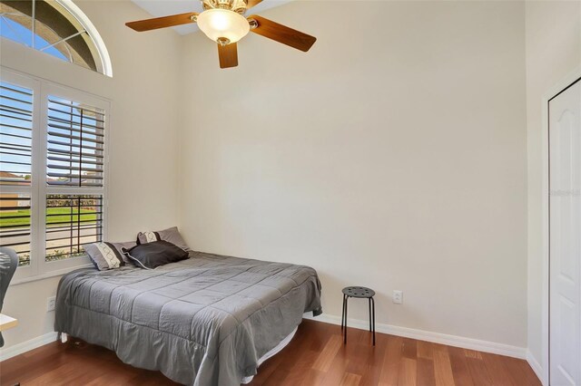 13708 Old Dock Rd, Orlando, FL 32828 - bedroom with wood finished floors, baseboards, and ceiling fan