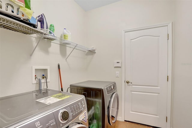 13708 Old Dock Rd, Orlando, FL 32828 - washroom featuring washer and dryer and light tile patterned floors