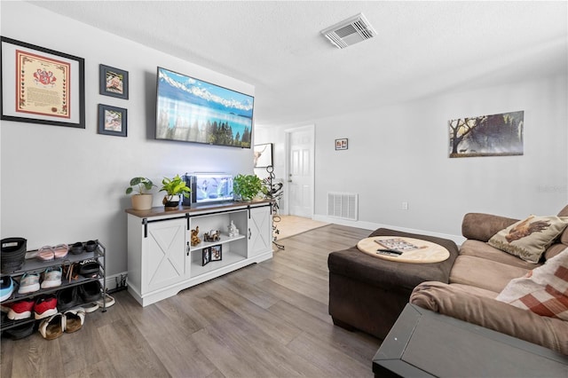9126 Greenbriar Ln, Port Richey, FL 34668 - living area with wood finished floors, baseboards, and a textured ceiling