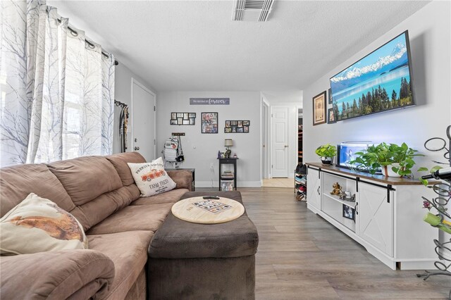9126 Greenbriar Ln, Port Richey, FL 34668 - living area featuring light wood-style flooring and baseboards