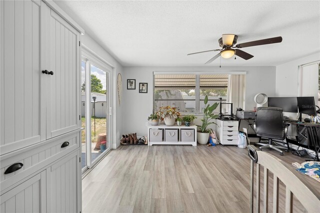 9126 Greenbriar Ln, Port Richey, FL 34668 - home office with ceiling fan and light wood-style flooring