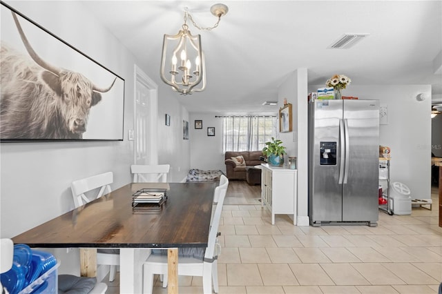 9126 Greenbriar Ln, Port Richey, FL 34668 - dining space with a chandelier and light tile patterned floors