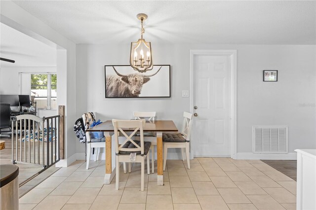9126 Greenbriar Ln, Port Richey, FL 34668 - dining area with a chandelier, baseboards, a desk, and light tile patterned floors