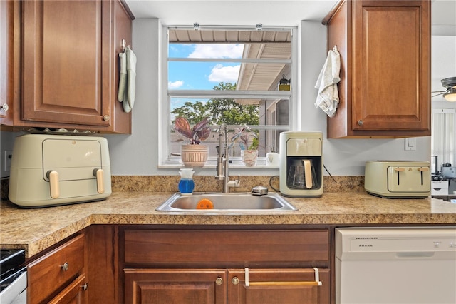 9126 Greenbriar Ln, Port Richey, FL 34668 - kitchen with dishwasher, a sink, stove, and brown cabinets