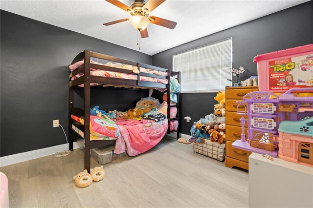 9126 Greenbriar Ln, Port Richey, FL 34668 - bedroom with wood finished floors, a ceiling fan, and baseboards