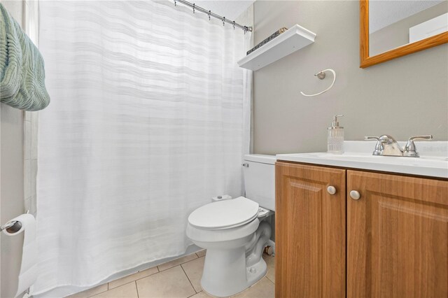 9126 Greenbriar Ln, Port Richey, FL 34668 - bathroom with tile patterned flooring, toilet, vanity, and a shower with shower curtain