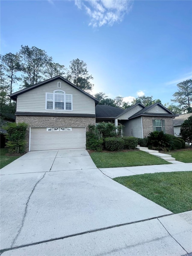 2244 NW 101st St, Gainesville, FL 32606 - view of front of house with an attached garage, concrete driveway, brick siding, and a front lawn