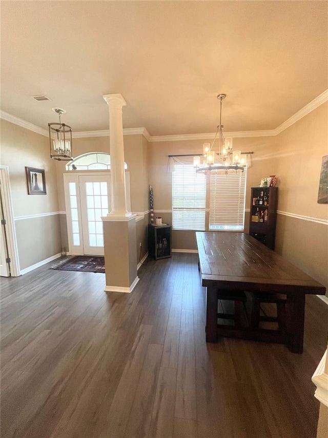 2244 NW 101st St, Gainesville, FL 32606 - unfurnished dining area with dark wood-style flooring, a chandelier, decorative columns, crown molding, and baseboards