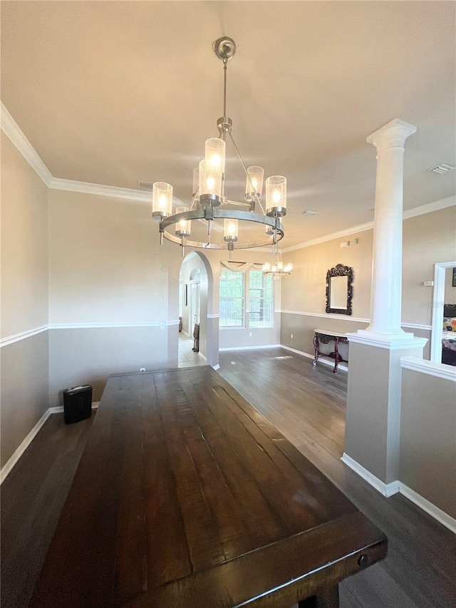 2244 NW 101st St, Gainesville, FL 32606 - unfurnished dining area with a chandelier, crown molding, wood finished floors, baseboards, and decorative columns