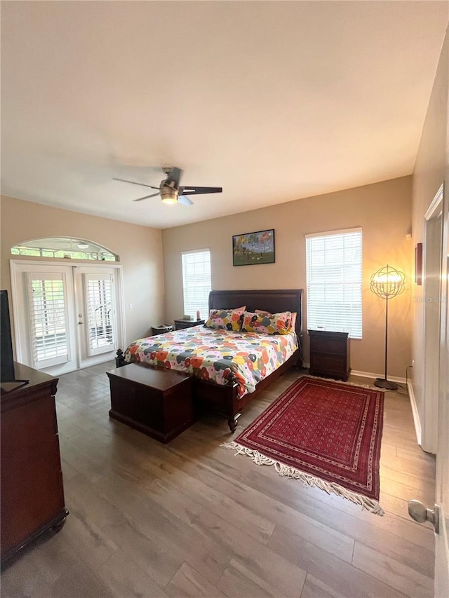 2244 NW 101st St, Gainesville, FL 32606 - bedroom featuring access to outside, wood finished floors, a ceiling fan, and baseboards